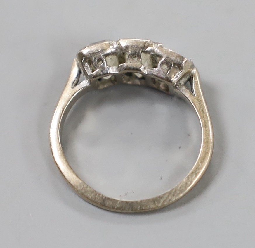 A modern 18ct white gold and two (ex three) stone graduated emerald cut diamond set ring, size G, gross weight 3.3 grams